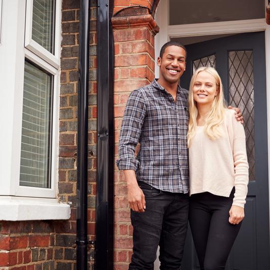 Couple standing in front of property