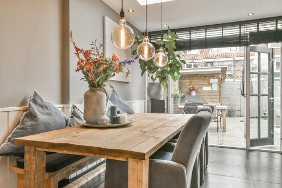 Dining table in home opening onto outdoor patio area